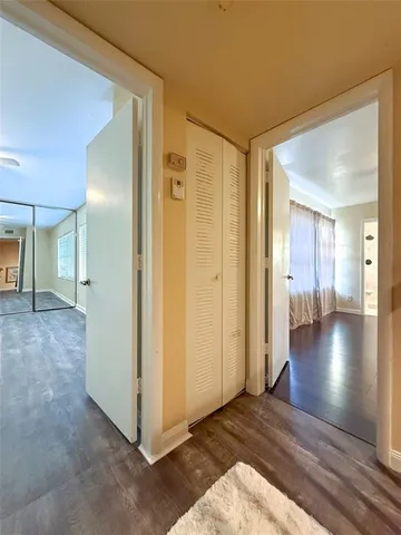 a view of a hallway with wooden floor
