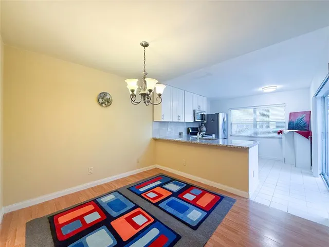 a living room with furniture and a kitchen view