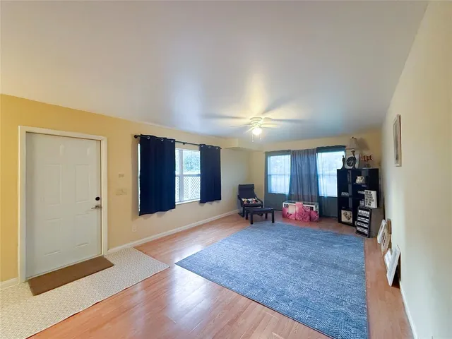 a view of a room with furniture and a window