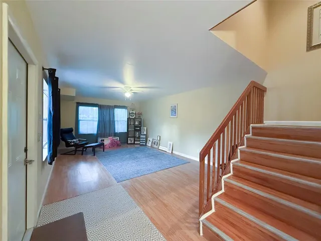 a view of a livingroom with furniture and staircase
