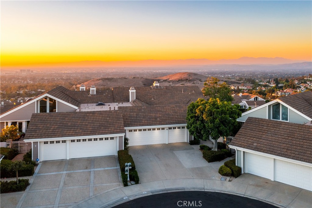 an aerial view of a house with a yard and balcony
