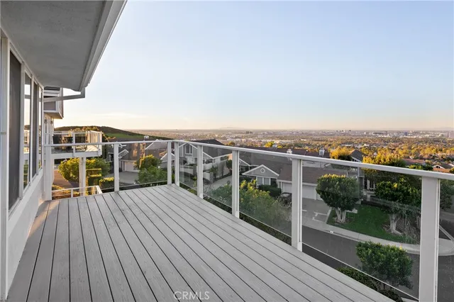 a view of a balcony with wooden floor and city view