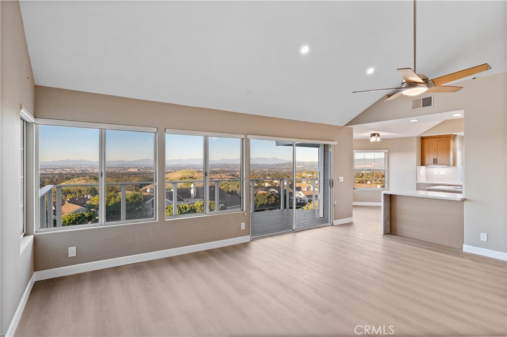 6 Saros, Unit 68 Irvine, CA 92603 - Photo 15 of 35 a view of an empty room with wooden floor and a window