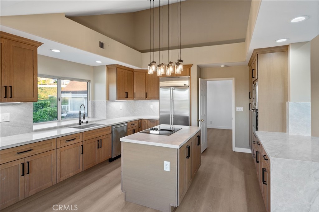 6 Saros, Unit 68 Irvine, CA 92603 - Photo 19 of 35 a kitchen that has a lot of cabinets in it and stainless steel appliances