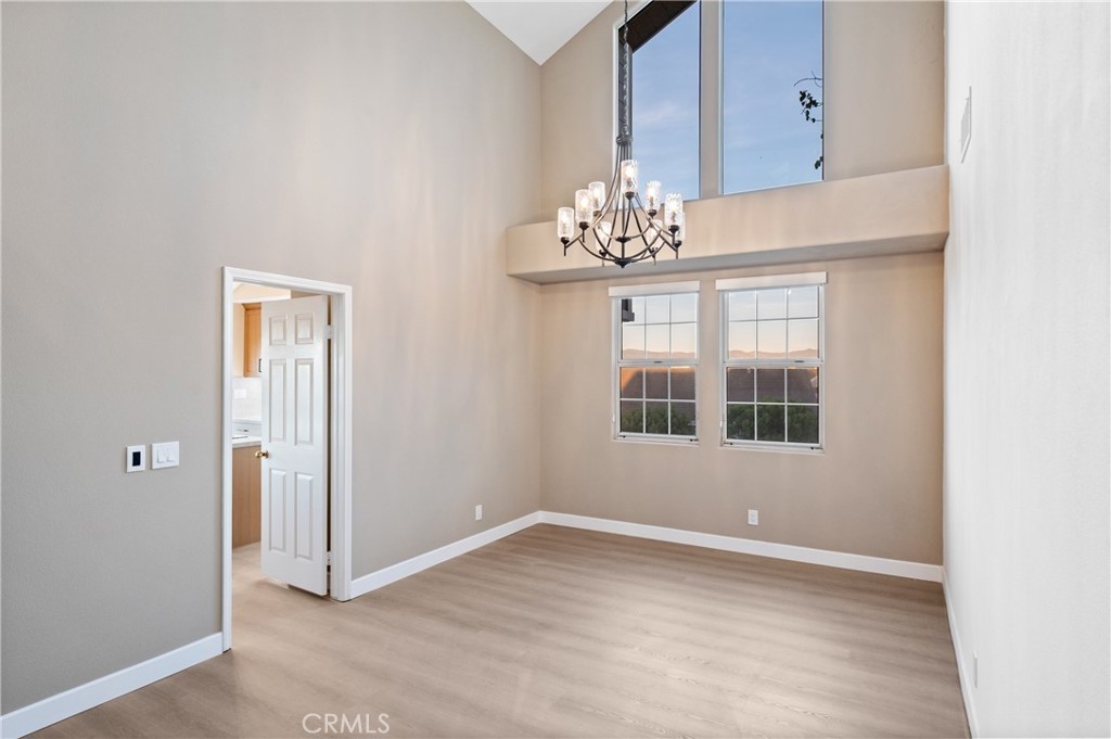 6 Saros, Unit 68 Irvine, CA 92603 - Photo 21 of 35 an empty room with chandelier fan and windows