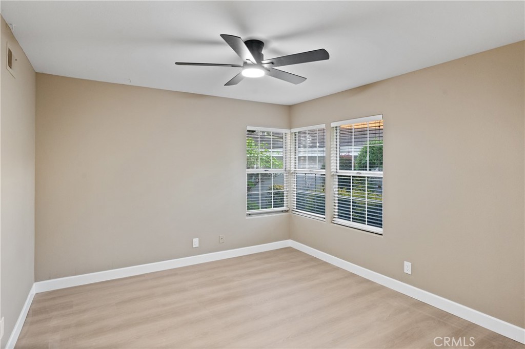 6 Saros, Unit 68 Irvine, CA 92603 - Photo 22 of 35 a view of a livingroom with a ceiling fan and wooden floor