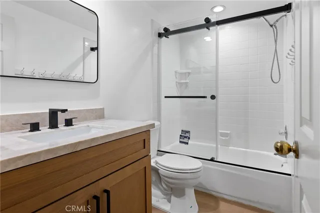 an empty room with window and ceiling fan