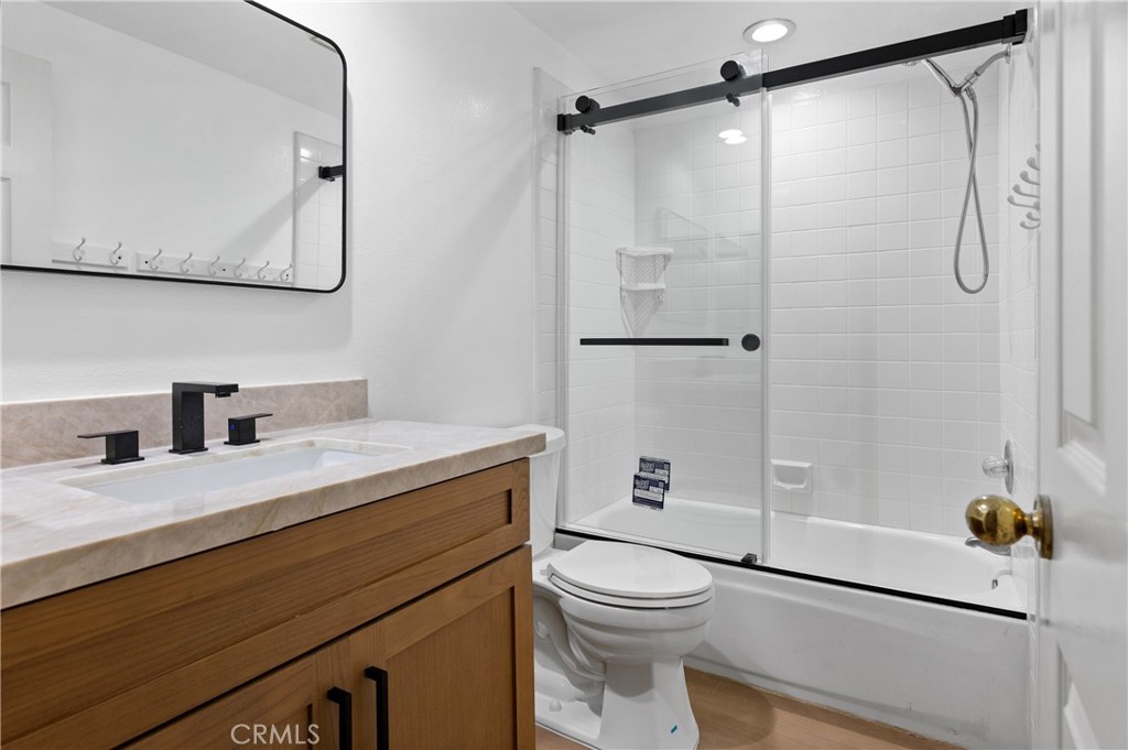 6 Saros, Unit 68 Irvine, CA 92603 - Photo 23 of 35 a bathroom with a granite countertop sink a toilet and shower