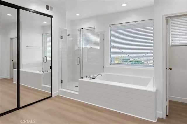 a spacious bathroom with a double vanity sink mirror and double