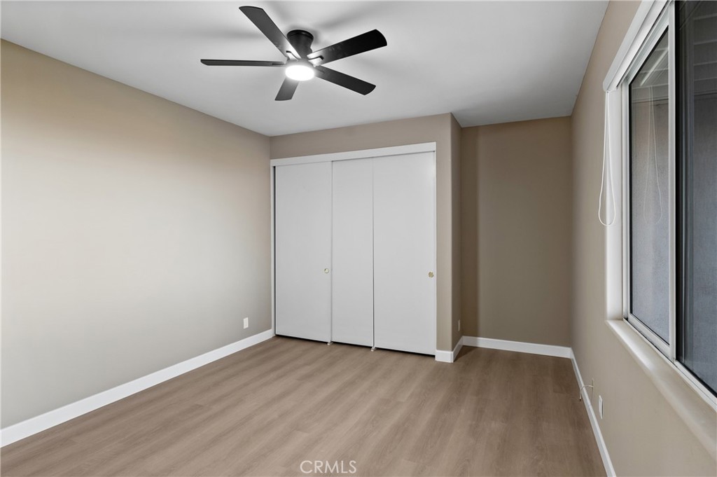 6 Saros, Unit 68 Irvine, CA 92603 - Photo 30 of 35 an empty room with wooden floor and windows