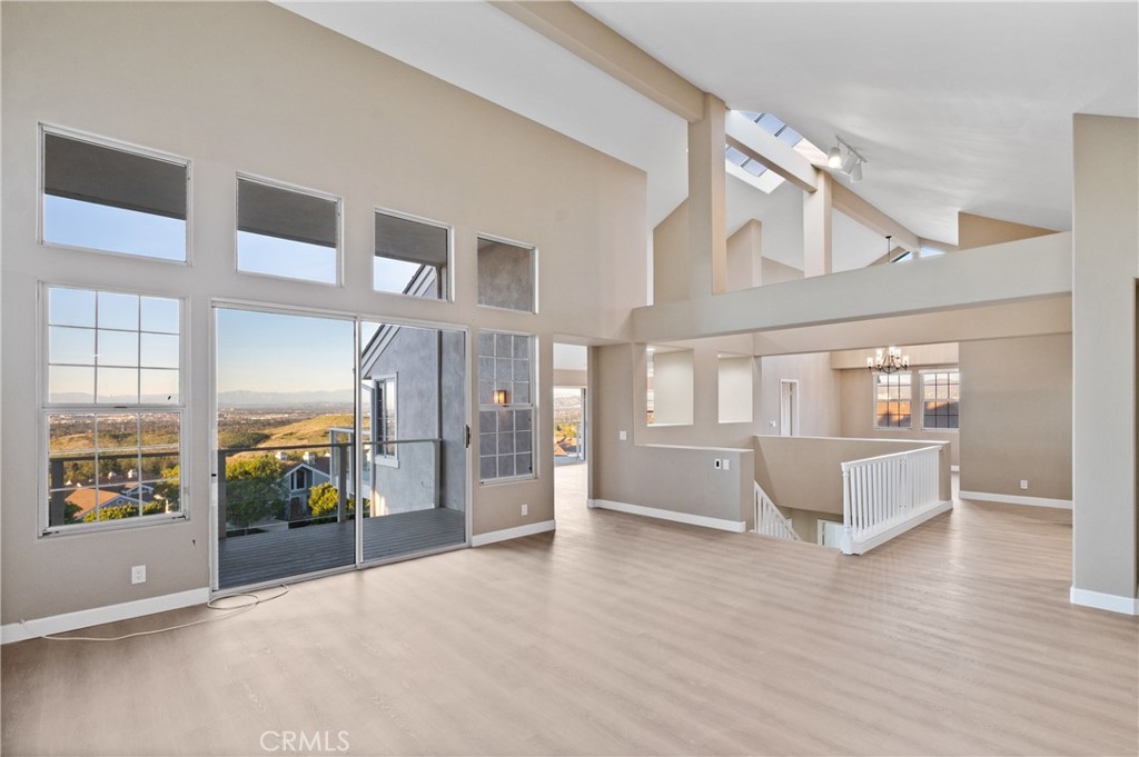 6 Saros, Unit 68 Irvine, CA 92603 - Photo 5 of 35 a view of an entryway with wooden floor and windows