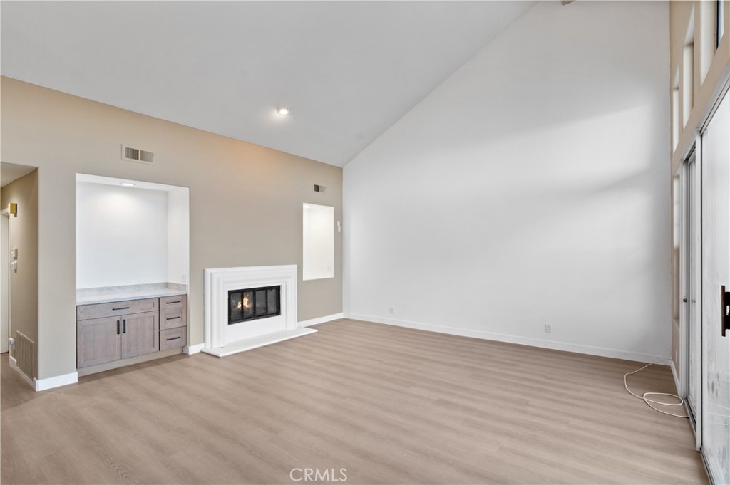 6 Saros, Unit 68 Irvine, CA 92603 - Photo 8 of 35 wooden floor in an empty room with a fireplace