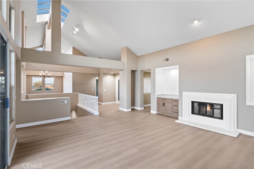 6 Saros, Unit 68 Irvine, CA 92603 - Photo 9 of 35 a view of a livingroom with an empty space and a fireplace