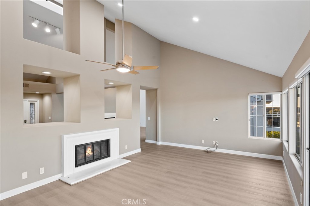 6 Saros, Unit 68 Irvine, CA 92603 - Photo 10 of 35 a view of a livingroom with an empty space and a fireplace