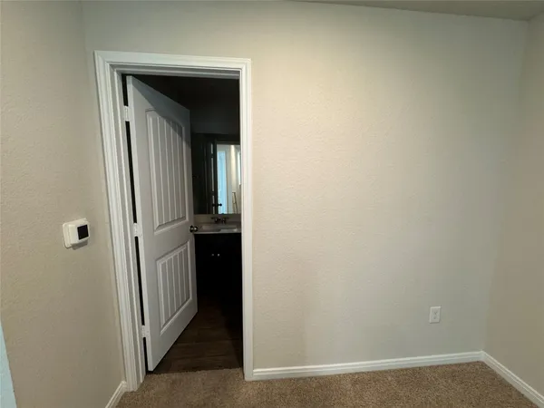 a view of a hallway with white walls