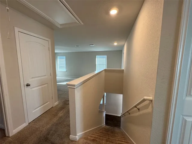 a view of a hallway with white walls