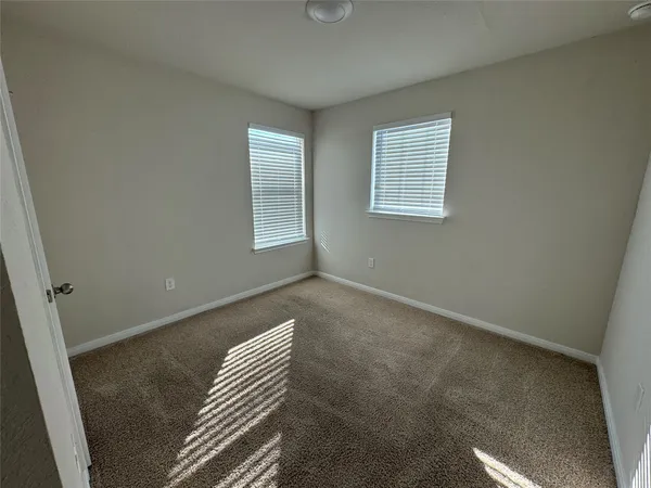 a view of a hallway with wooden floor and closet