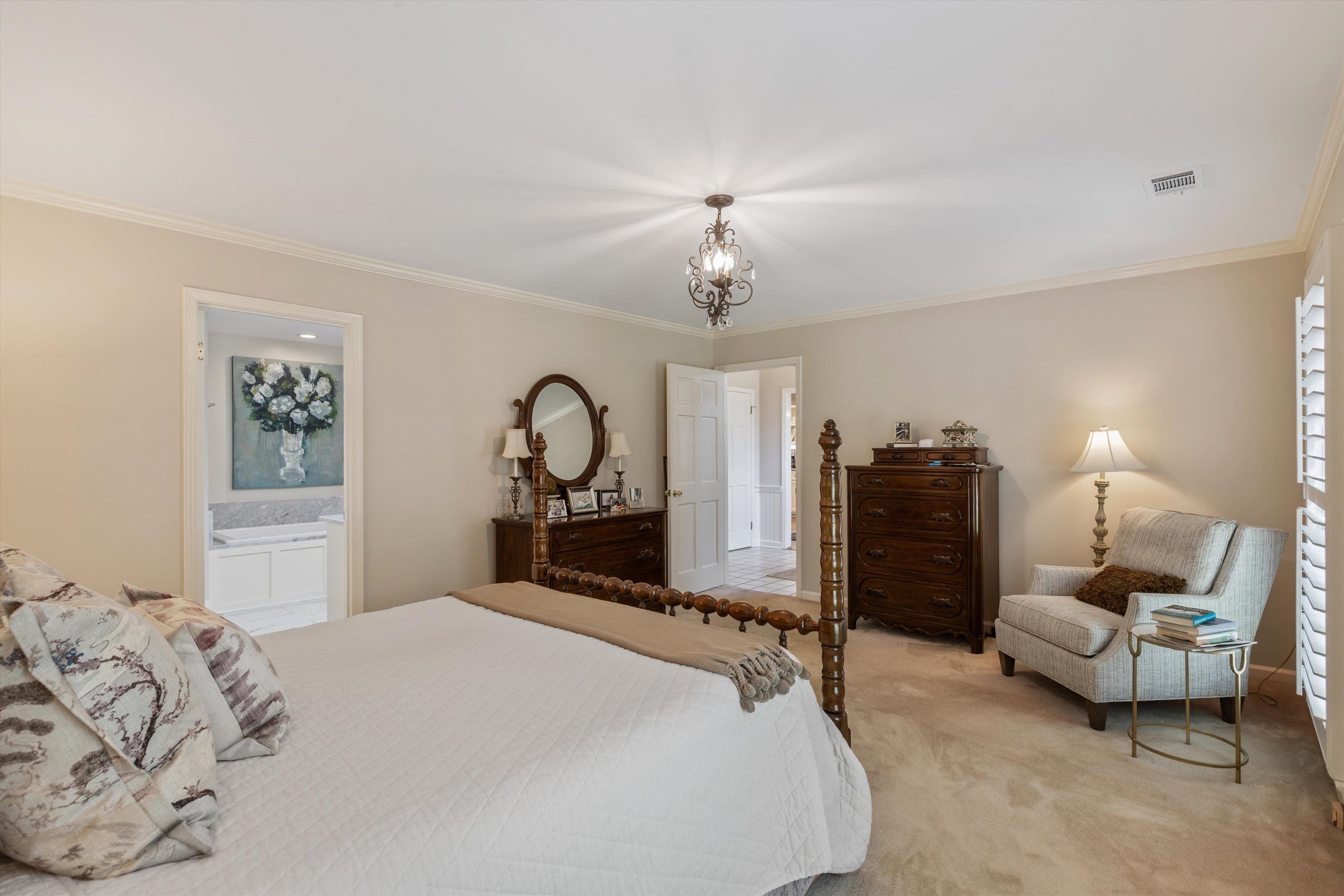 560 Silverman Drive Collierville, TN 38017 - Photo 13 of 31 a bedroom with bed and a chandelier