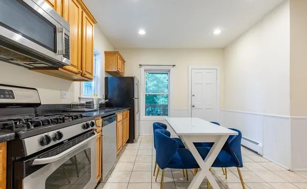 a kitchen with stainless steel appliances a stove a sink and a refrigerator