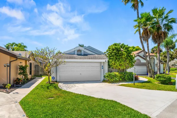 a front view of a house with a yard and a garage