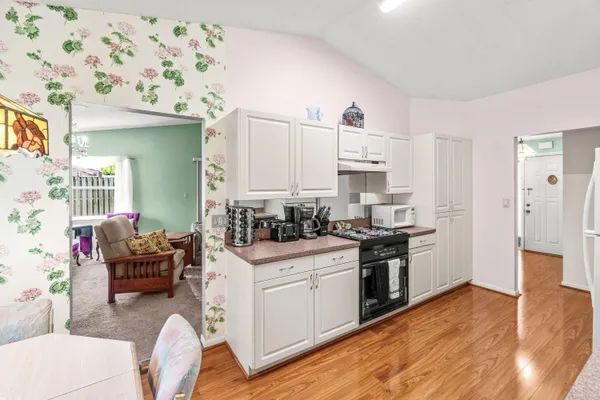 a kitchen with a table chairs stove and refrigerator