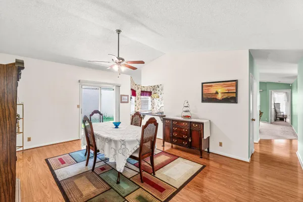 a view of a dining room with furniture and wooden floor