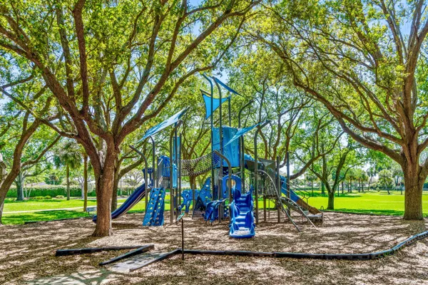 a view of a park with large trees