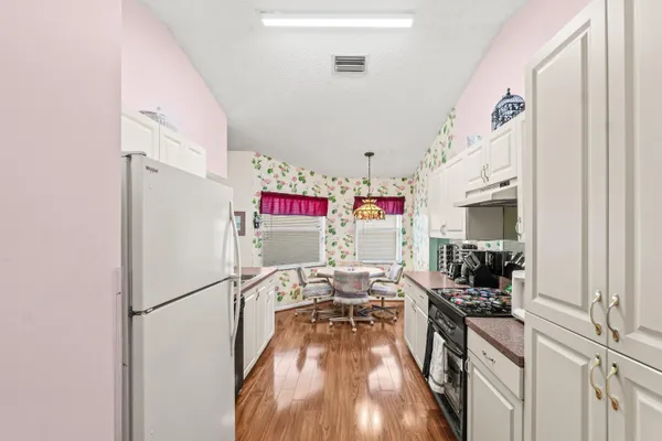 a view of a kitchen with appliances and cabinets