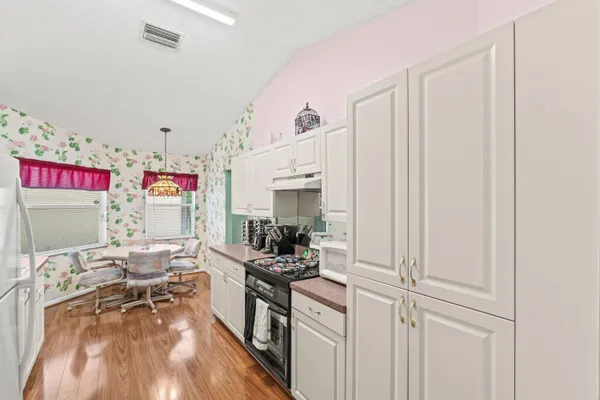 a dinning area with kitchen island granite countertop furniture and a kitchen view