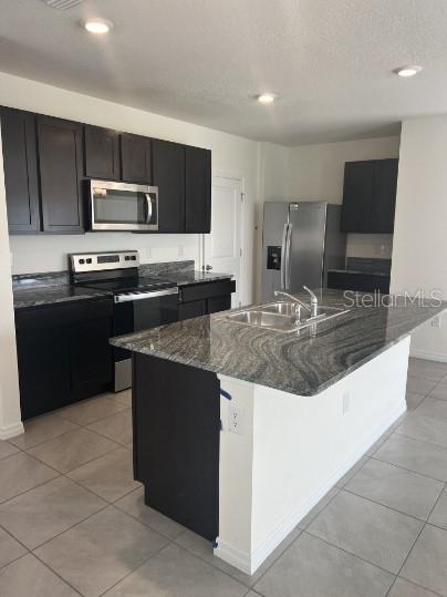 31284 Penny Surf Loop Wesley Chapel, FL 33545 - Photo 7 of 15 a kitchen with kitchen island granite countertop a sink dishwasher stove and refrigerator