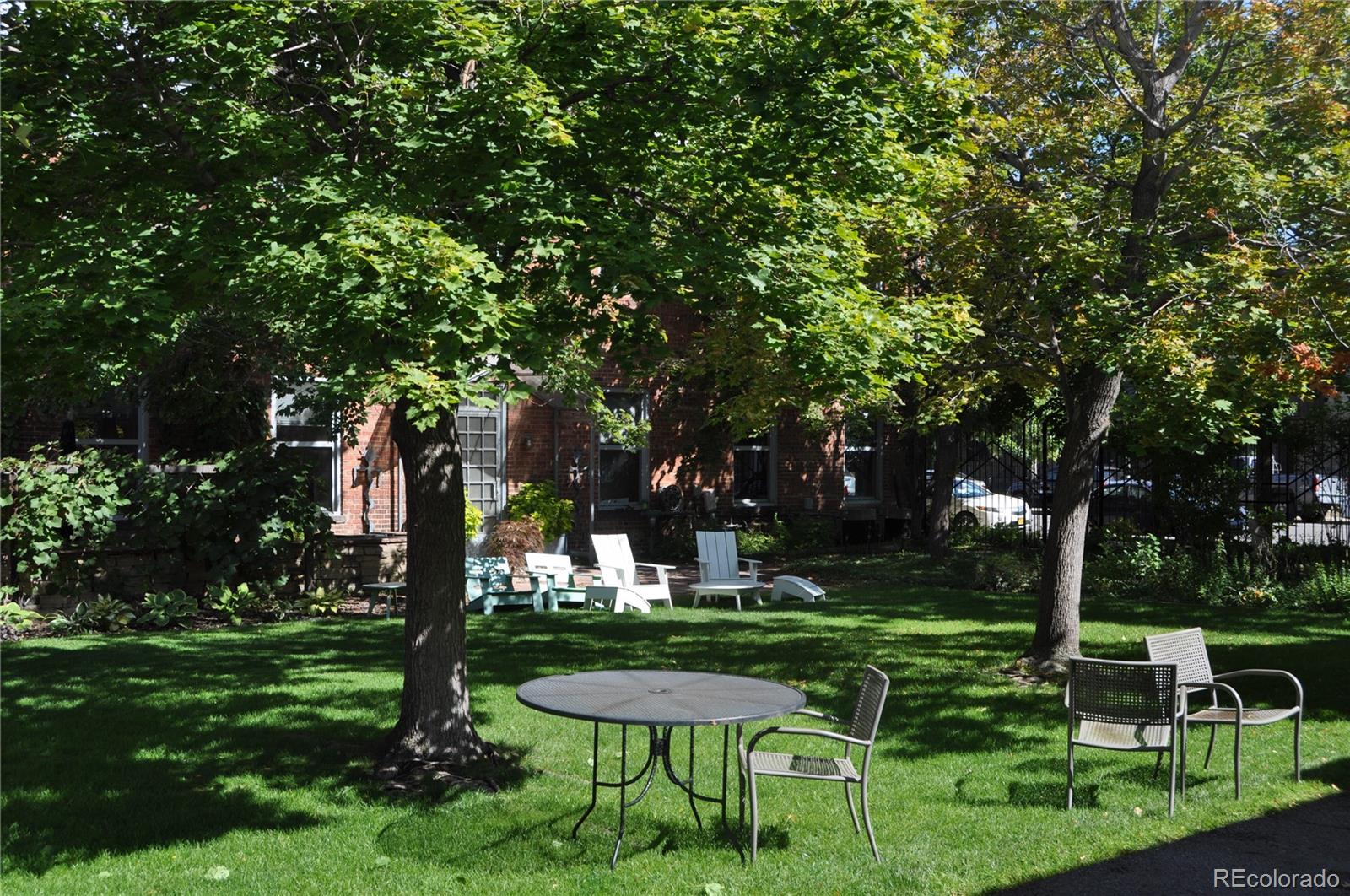 3309 Blake Street, Unit 207 Denver, CO 80205 - Photo 18 of 26 a view of a table and chairs in the garden