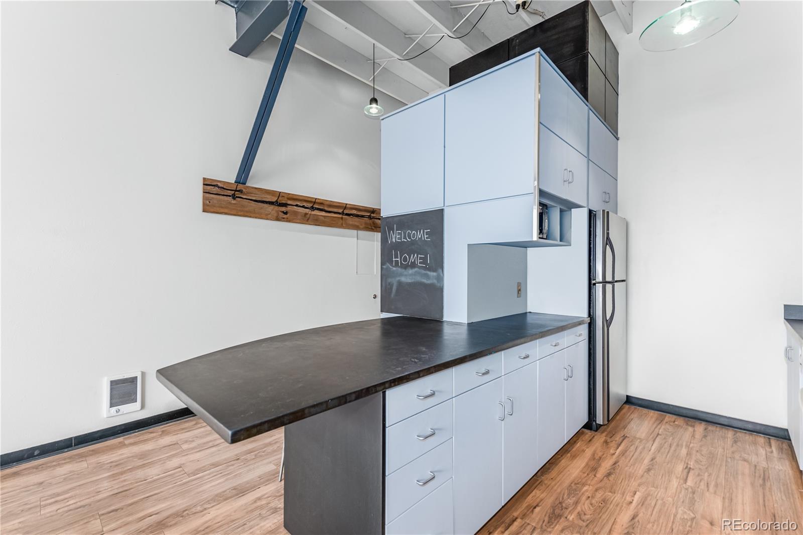 3309 Blake Street, Unit 207 Denver, CO 80205 - Photo 8 of 26 a view of cabinets and wooden floor