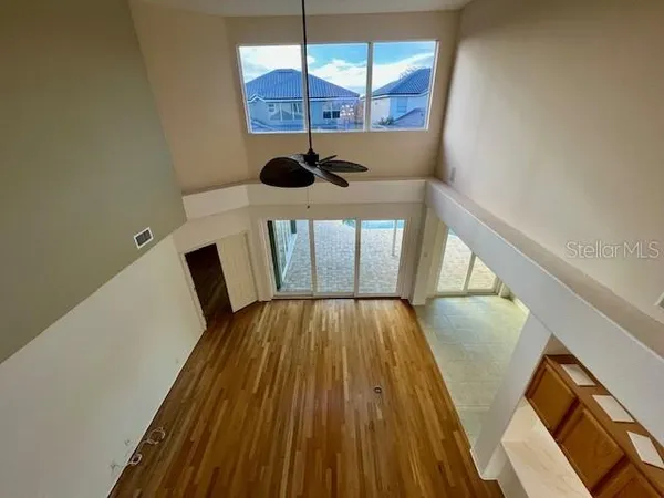 a view of a hallway with wooden floor