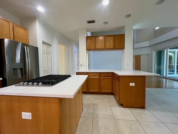 a kitchen with stainless steel appliances a sink stove and refrigerator
