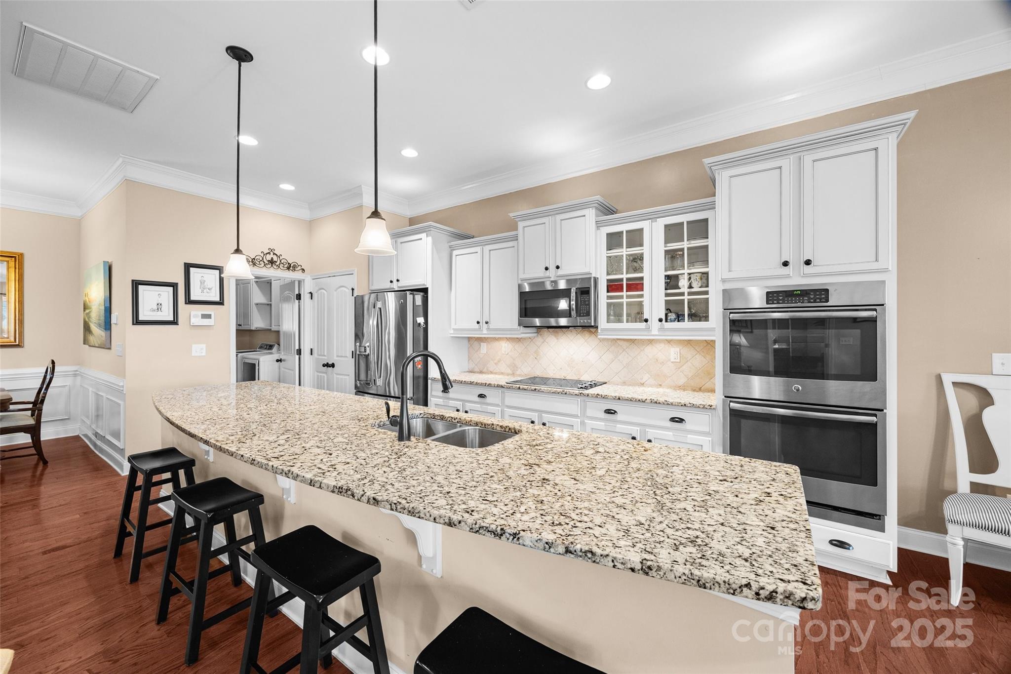 1617 Fig Branch Road Clover, SC 29710 - Photo 16 of 33 a kitchen with stainless steel appliances granite countertop sink stove and white cabinets with wooden floor