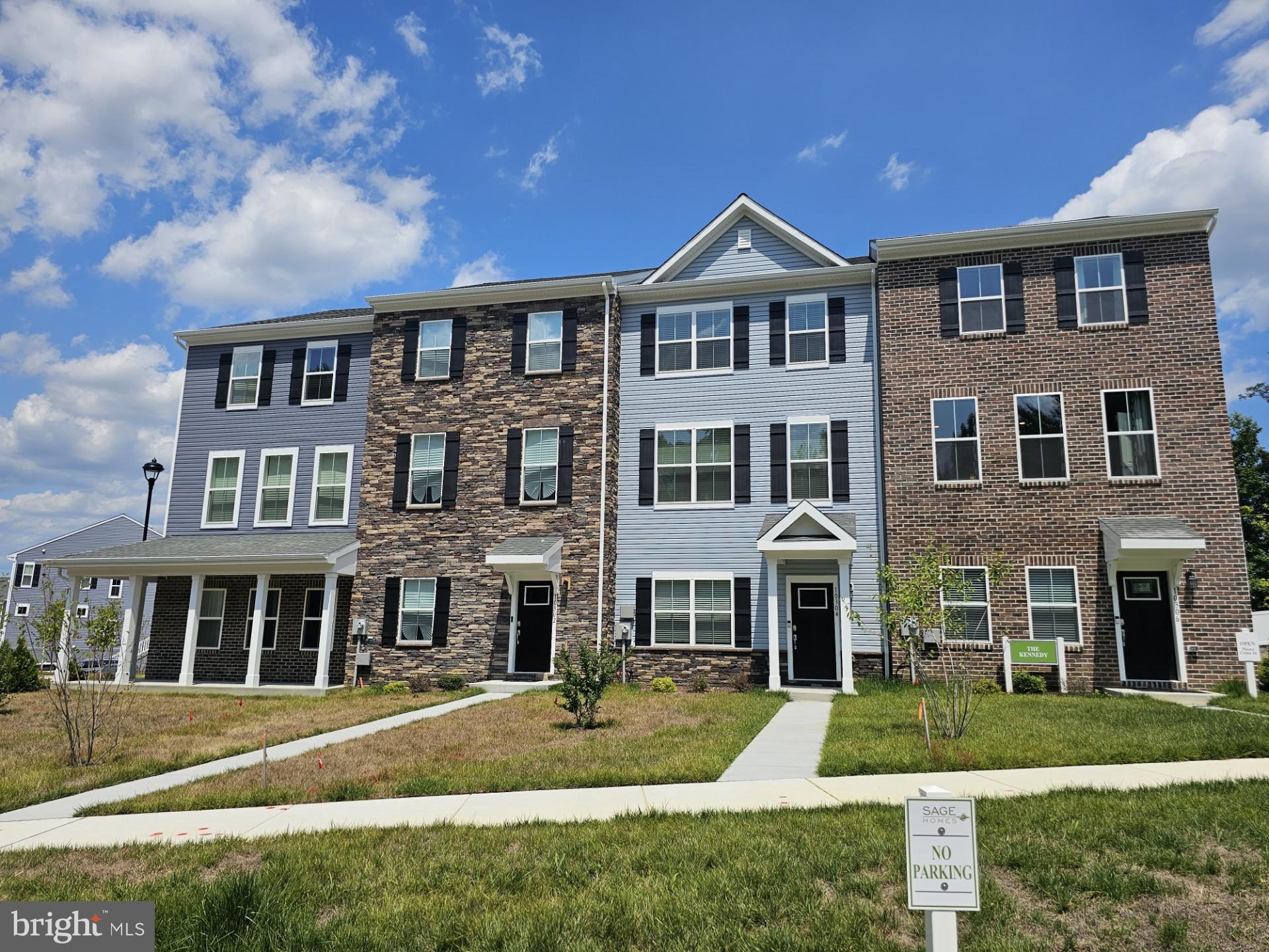 a front view of a residential apartment building with a yard