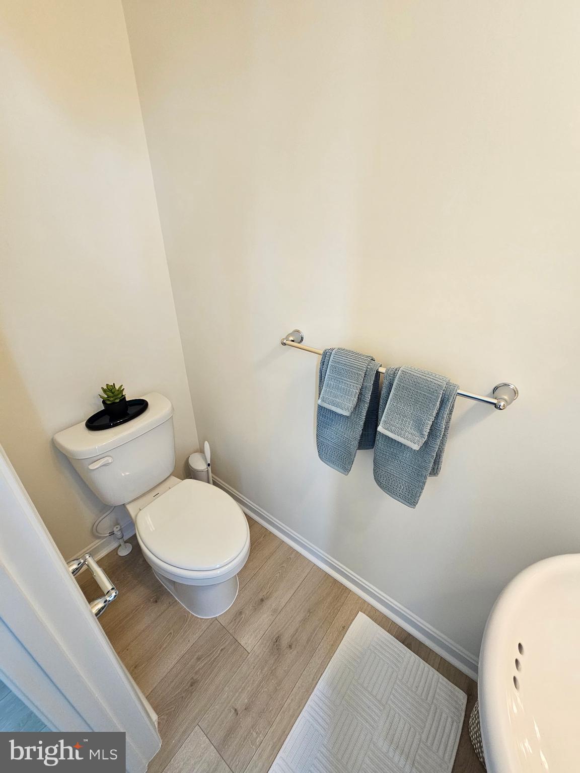 7304 Roxy Run, Unit 8 Clinton, MD 20735 - Photo 14 of 27 a white toilet sitting next to a bathroom sink