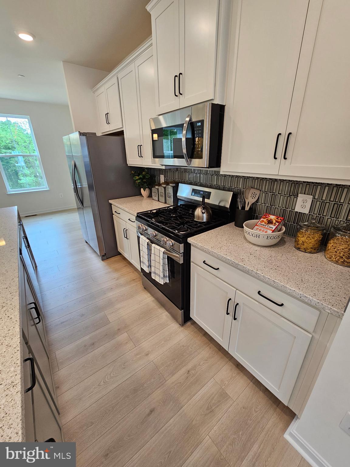 7304 Roxy Run, Unit 8 Clinton, MD 20735 - Photo 4 of 27 a kitchen with stainless steel appliances granite countertop a stove a sink and a refrigerator
