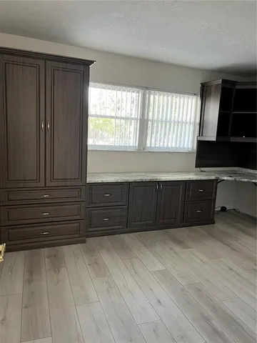 a room with a dresser and a window