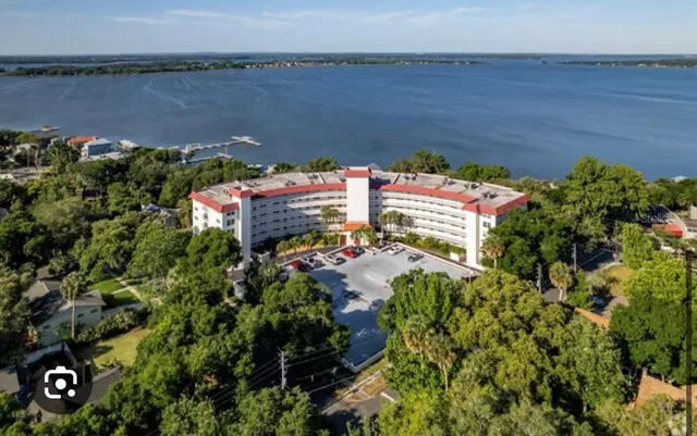 an aerial view of a house with a lake view