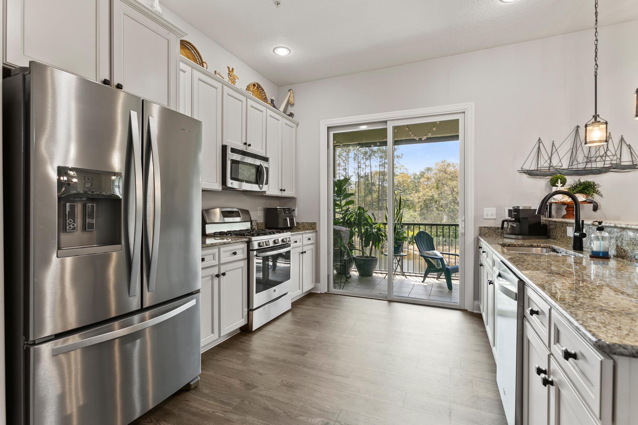 121 Grand Ravine Drive St. Augustine, FL 32086 - Photo 11 of 44 a kitchen with stainless steel appliances a refrigerator sink and microwave