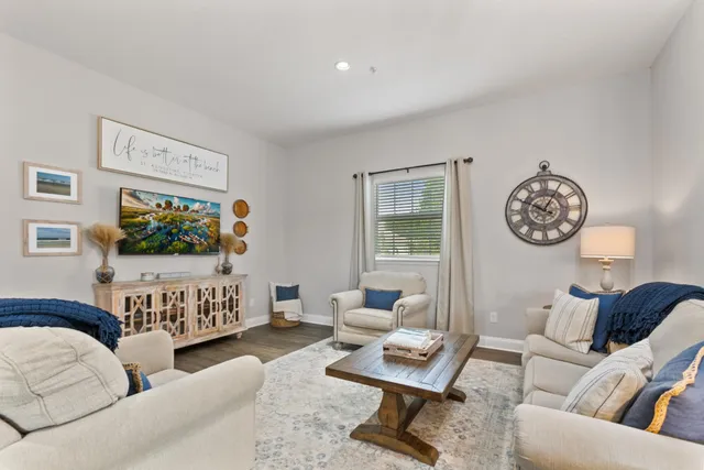 a living room with furniture a rug and a flat screen tv