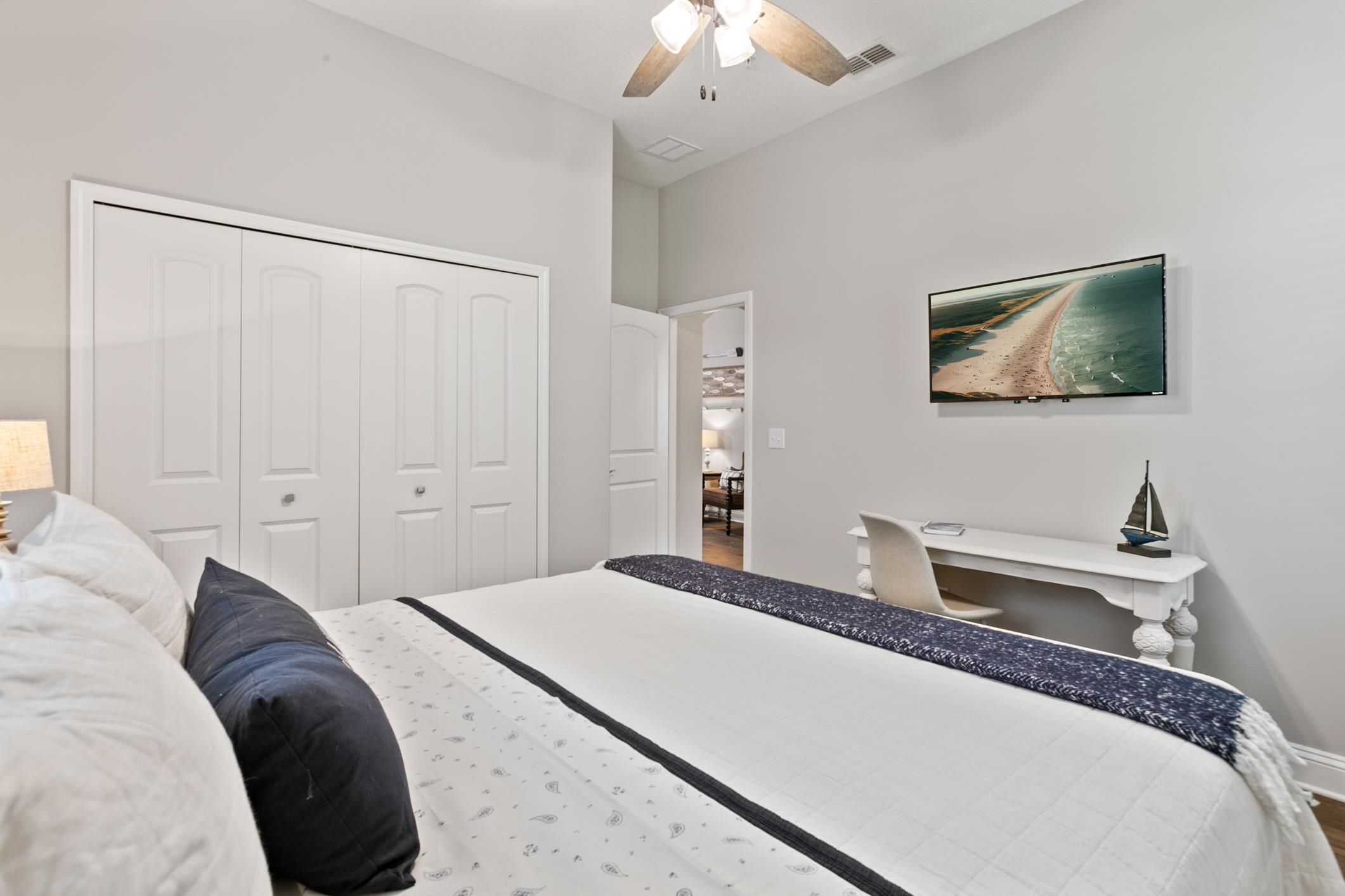 121 Grand Ravine Drive St. Augustine, FL 32086 - Photo 26 of 44 a bedroom with a bed and a chandelier