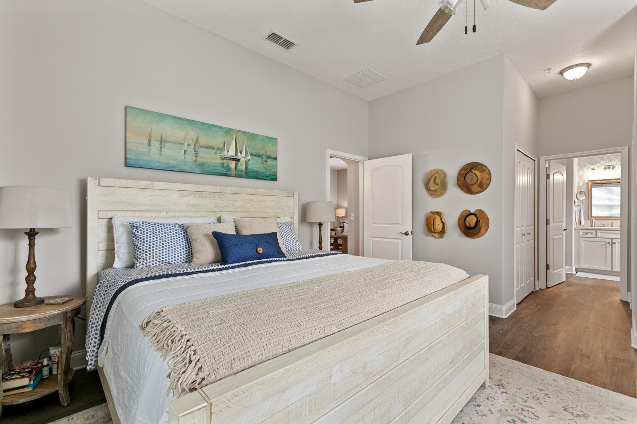 121 Grand Ravine Drive St. Augustine, FL 32086 - Photo 30 of 44 a bedroom with a large bed and a lamp on dresser