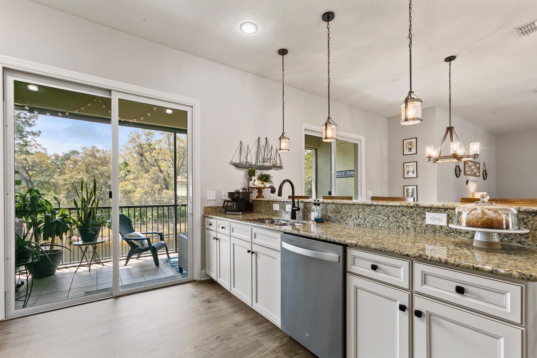121 Grand Ravine Drive St. Augustine, FL 32086 - Photo 10 of 44 a kitchen with sink cabinets and outdoor space