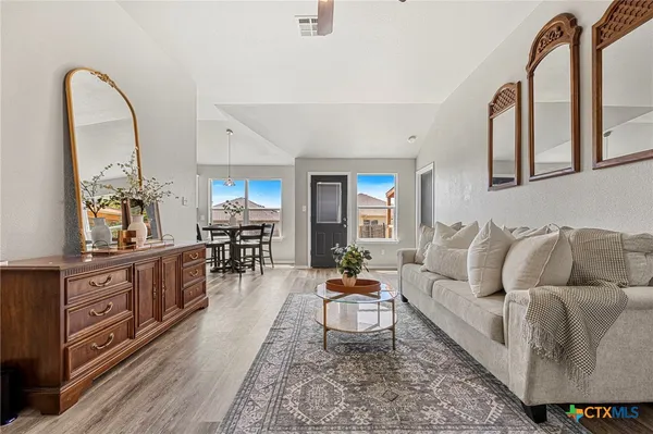 a living room with furniture and wooden floor