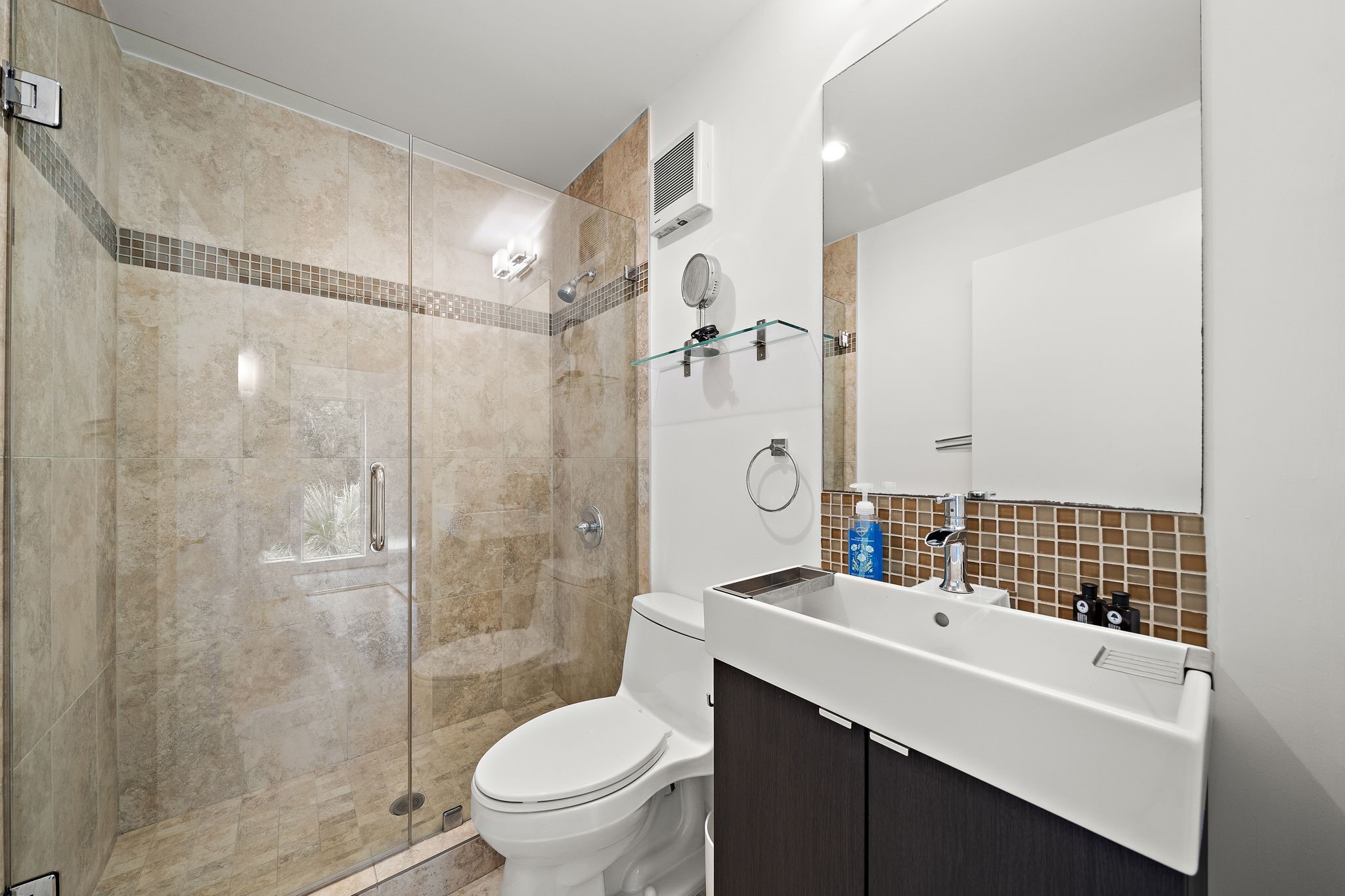118 Angel Leaf Road The Woodlands, TX 77380 - Photo 29 of 50 Modern bathroom In studio apartment featuring a vessel sink, mosaic tile accents, and a deep soaking tub with serene natural views.
