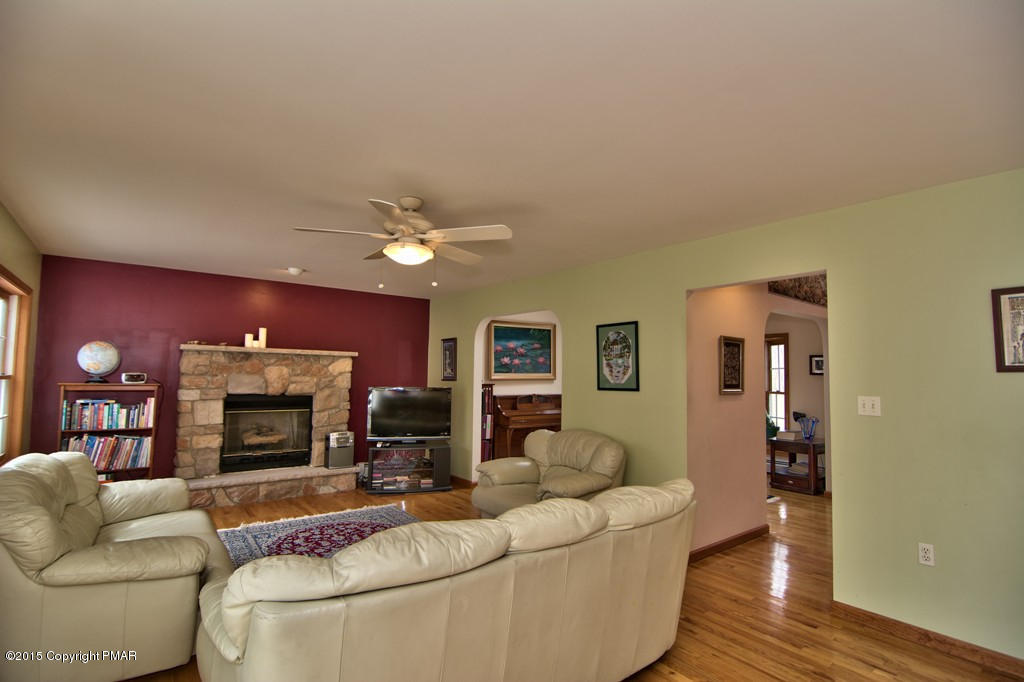 307 Rosewood Road Stroudsburg, PA 18360 - Photo 54 of 107 a living room with furniture a fireplace and a flat screen tv
