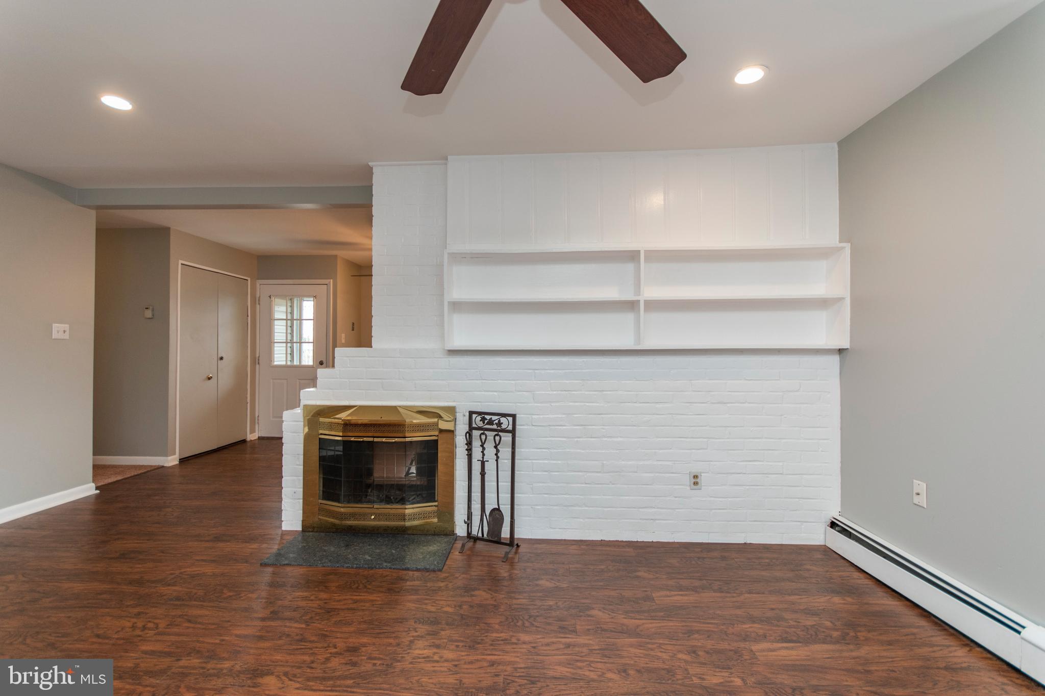 32 Gentle Road Levittown, PA 19057 - Photo 12 of 32 an empty room with wooden floor a fireplace and windows
