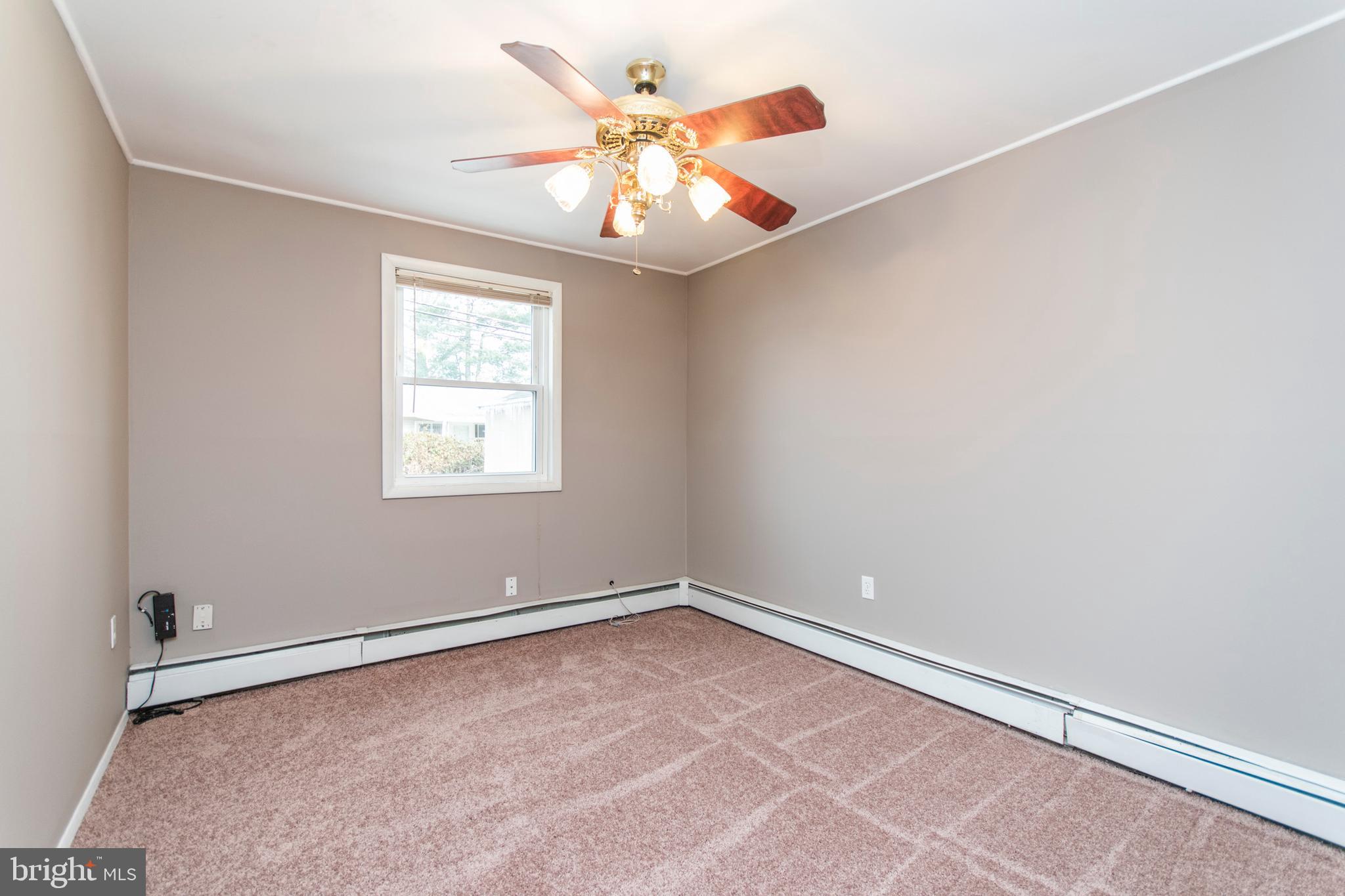 32 Gentle Road Levittown, PA 19057 - Photo 22 of 32 an empty room with chandelier fan and windows